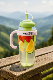 Clear water bottle with fruit infusers on a wooden surface with a mountainous background